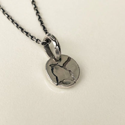silver pendant round with rough texture